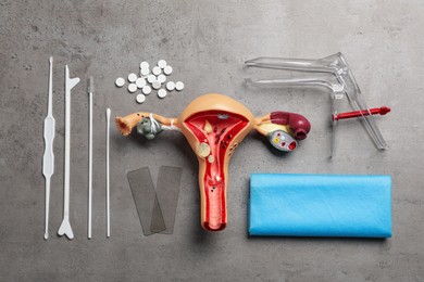 Gynecological examination kit on grey table, flat lay