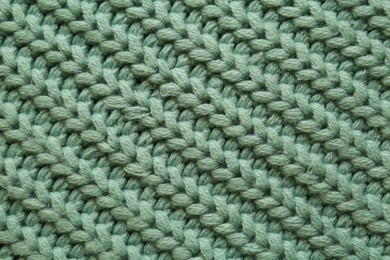 Beautiful pale green knitted fabric as background, top view