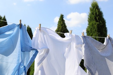 Clean clothes hanging on washing line outdoors. Drying laundry