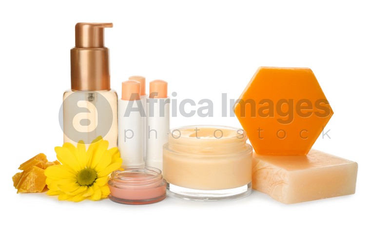 Natural beeswax and different cosmetic products on white background