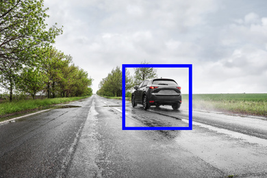 Wet suburban road with scanner frame on car outdoors. Machine learning