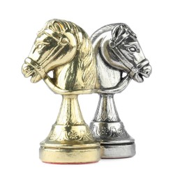 Silver and golden knights on white background. Chess pieces
