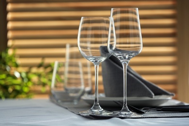 Table setting with empty wine glasses and napkin