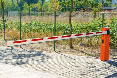 Closed boom barrier on sunny day outdoors