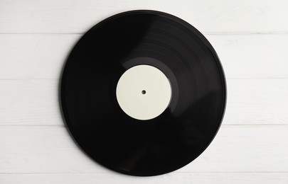 Vintage vinyl record on white wooden table, top view