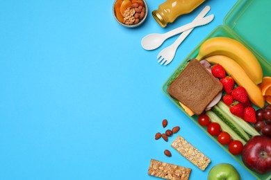 Photo of Flat lay composition with tasty food and cutlery on light blue background, space for text. School dinner