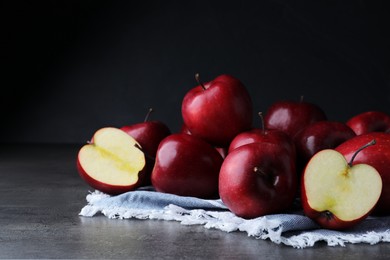 Fresh ripe red apples on grey table