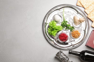 Flat lay composition with symbolic Passover (Pesach) items on color background, space for text