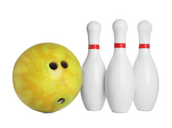 Yellow bowling ball and pins isolated on white