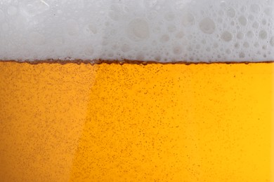 Photo of Tasty beer with foam as background, closeup