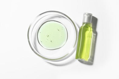 Photo of Petri dish and bottle with sample on white background, top view