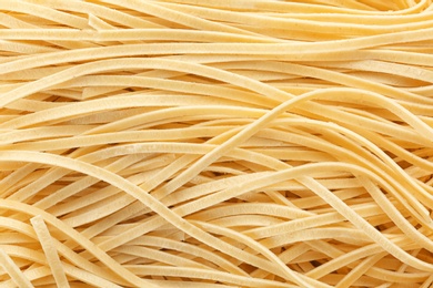 Quick cooking noodles as background, closeup view
