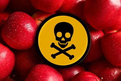 Skull and crossbones sign on fresh apples, closeup. Be careful - toxic