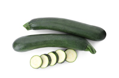 Cut and whole green ripe zucchini isolated on white, top view