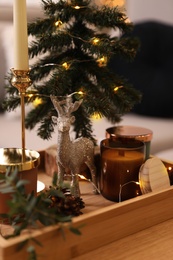 Composition with decorative Christmas tree and reindeer on wooden tray, closeup
