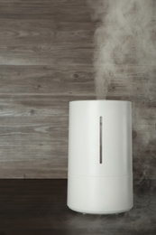 New modern air humidifier on wooden table