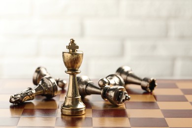 Chessboard with game pieces on light background