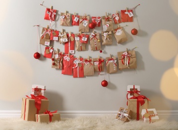 Christmas advent calendar hanging on wall above gift boxes