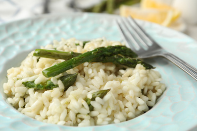 Delicious risotto with asparagus in plate, closeup