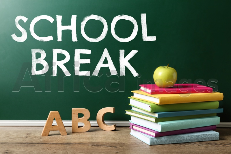 Image of Text School Break on green chalkboard near table. Seasonal holidays