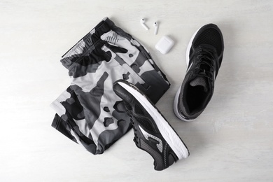 Flat lay composition with stylish sport shoes on light background