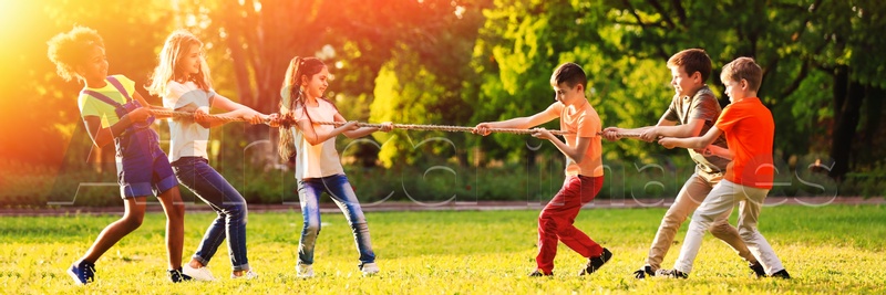 Cute little children playing with rope outdoors on sunny day. Banner design