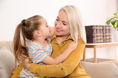 Mature woman with her little granddaughter at home