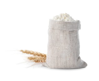 Sack with flour and wheat spikes on white background