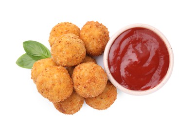 Photo of Pile of delicious fried tofu balls, ketchup and basil on white background, top view