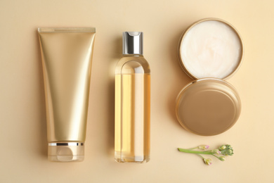 Flat lay composition with cosmetic products on beige background
