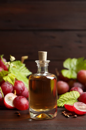 Bottle of natural grape seed oil on wooden table. Organic cosmetic