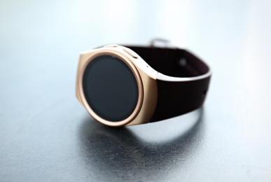 Modern stylish smart watch on grey table, closeup