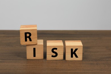 Cubes with word Risk on wooden table