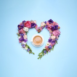 Beautiful heart shaped floral composition with cup of coffee on turquoise background, flat lay