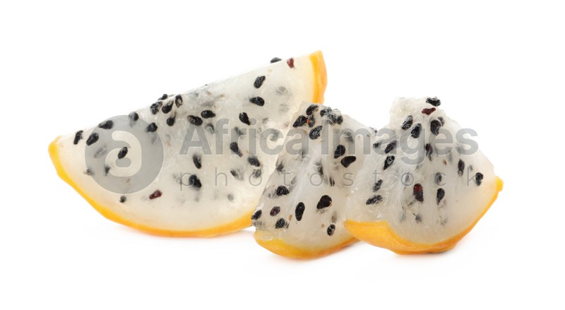 Slices of delicious yellow pitahaya fruit on white background
