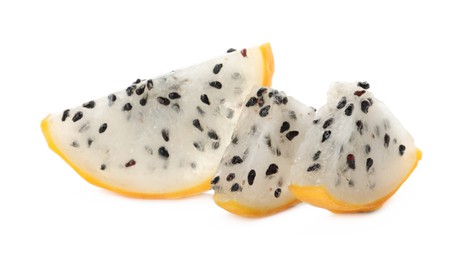 Slices of delicious yellow pitahaya fruit on white background