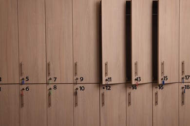 Many wooden lockers with keys and numbers on doors