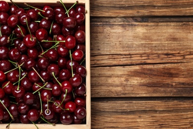 Sweet juicy cherries on wooden table, top view. Space for text