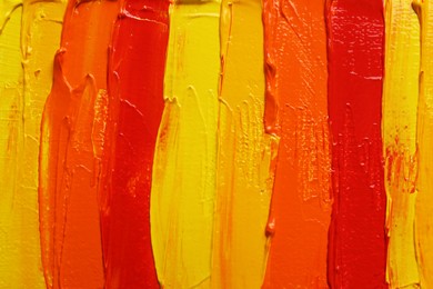 Photo of Strokes of colorful oil paints as background, closeup