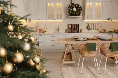 Beautiful Christmas tree in spacious kitchen, closeup. Space for text