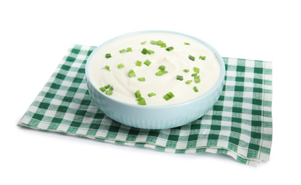 Fresh sour cream with onion and fabric on white background
