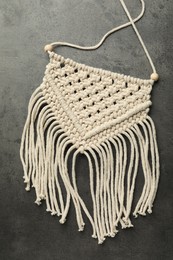 Stylish beige macrame on grey table, top view