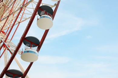 Beautiful large Ferris wheel outdoors, low angle view. Space for text