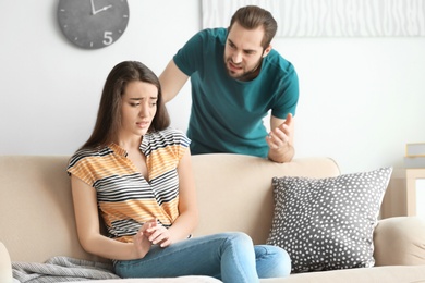 Young couple having argument in living room