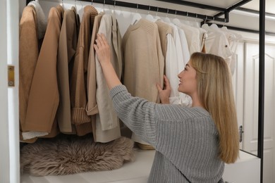 Young woman choosing outfit in dressing room