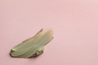 Sample of face cream on pink background, top view. Space for text