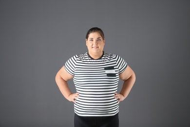 Photo of Portrait of overweight woman on gray background