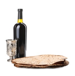 Tasty matzos, wine and goblet on white background. Passover (Pesach) celebration