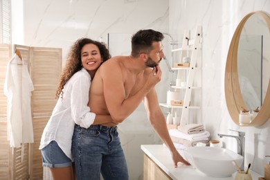 Lovely couple enjoying each other in bathroom at home