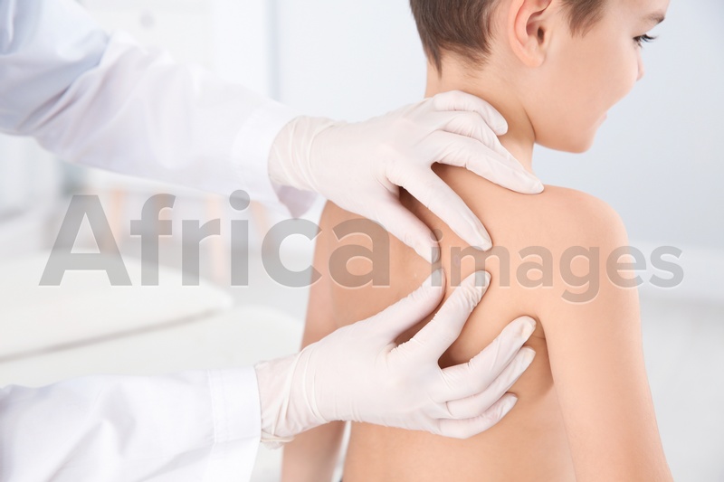 Dermatologist examining little boy's birthmark in clinic